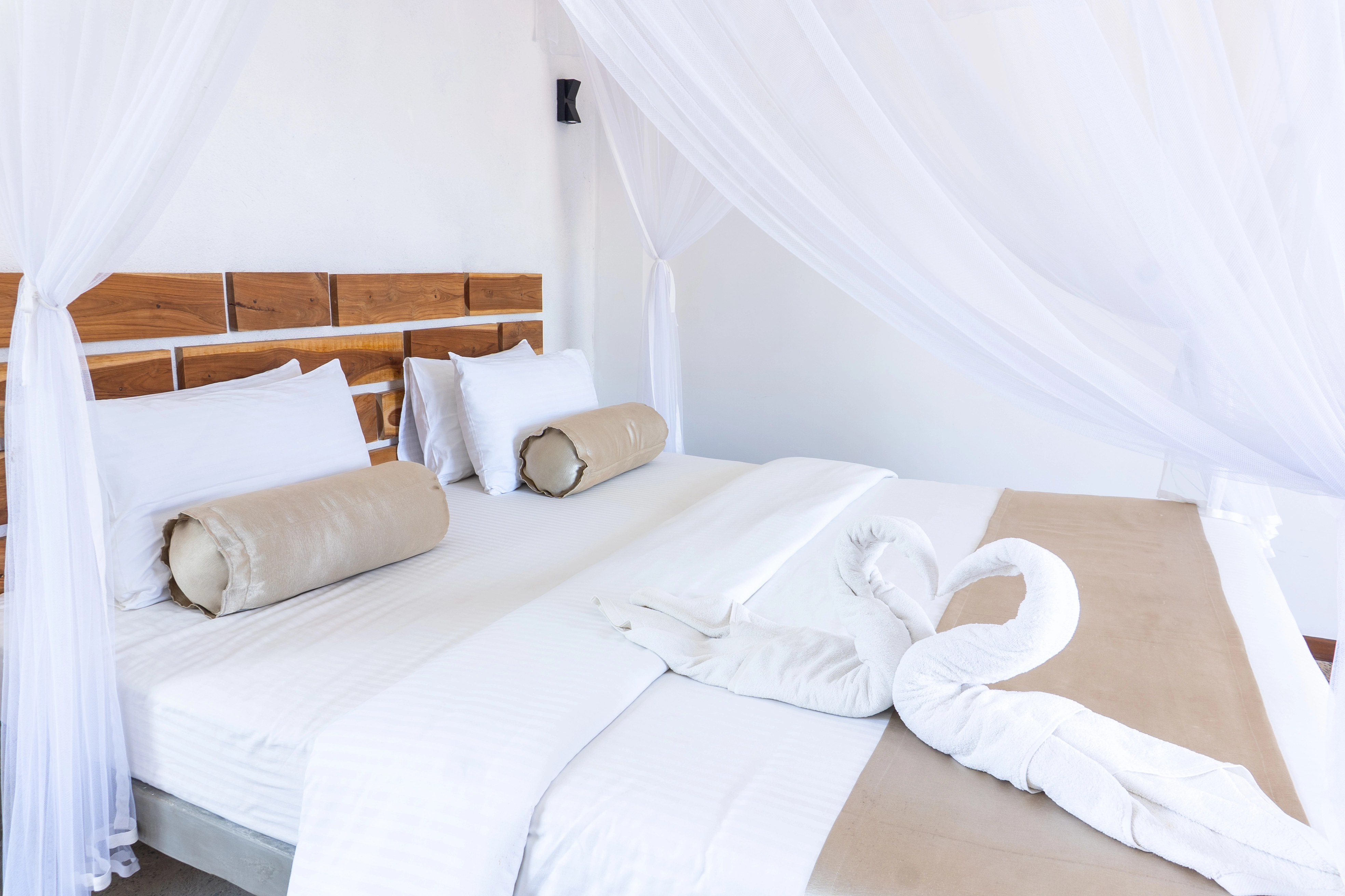 Close-up of freshly made bed with plush pillows and minimalist styling