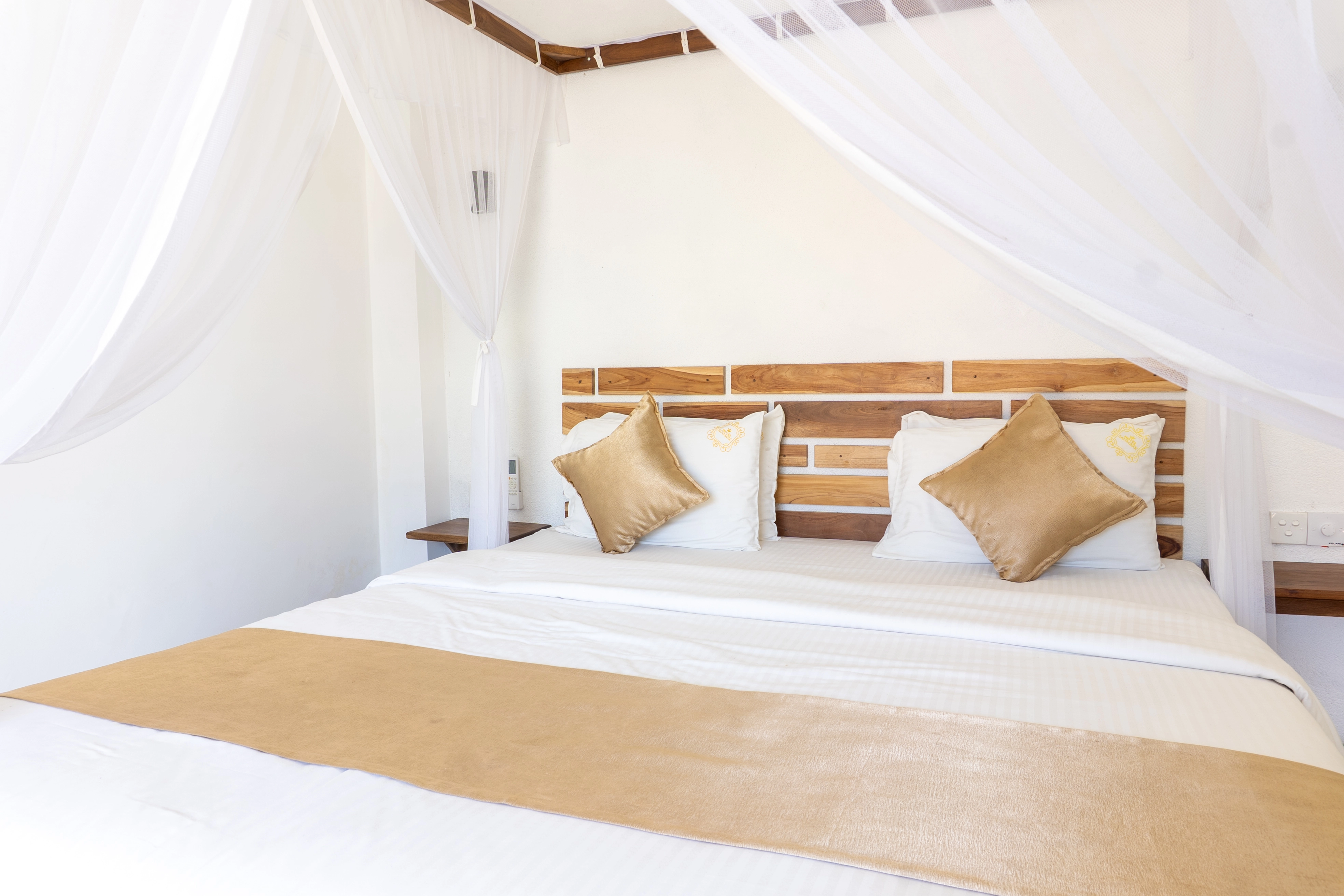 Detail of guest room bedding showing clean linens and a welcoming atmosphere