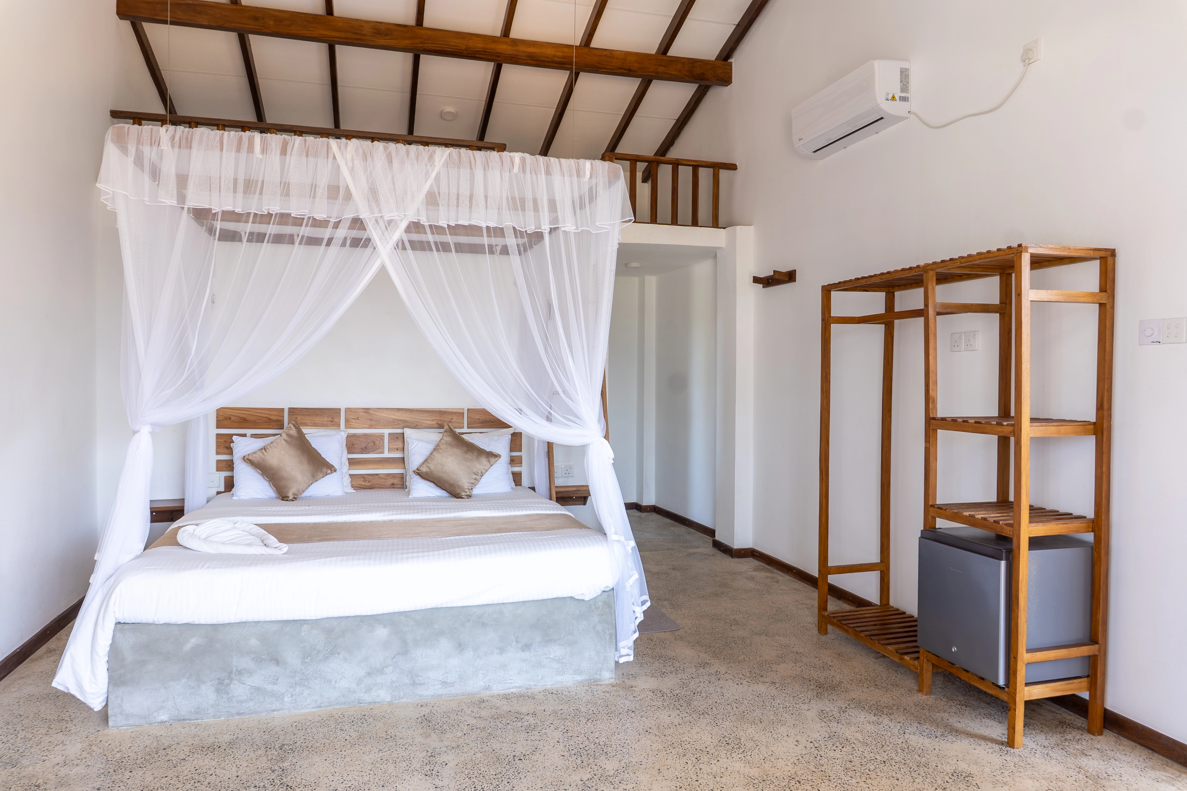 Wide view of a bright guest room with garden access and natural light